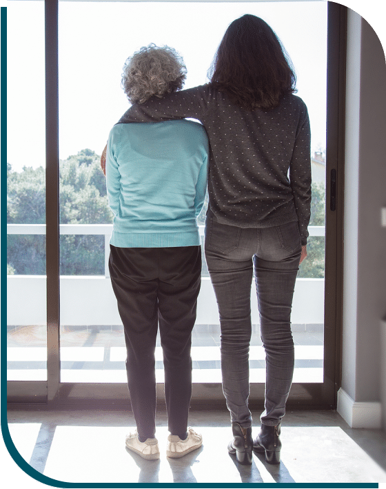 two women are standing near window two women are standing near window photo